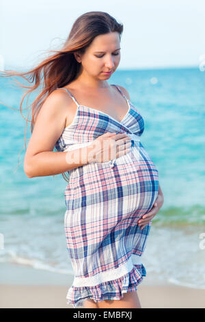 Beautiful pregnant woman on the beach Stock Photo