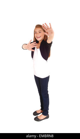 A pretty eight year old girl holding her hand up smiling, and saying NO, isolated on white background. Stock Photo