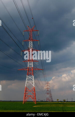 Electricity pole under cloudy sky Stock Photo