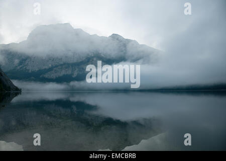 early morning mist over Altausseer See near Seeklause with view to Trisselwand, Styria, Austria Stock Photo