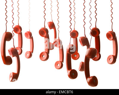 group of red handsets from vintage phones hanging against white background. selective focus Stock Photo