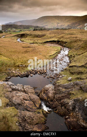 Ireland, Co Galway, Connemara, Maumturk Mountains, stream cutting through boggy land Stock Photo