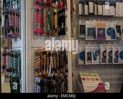 Racks loaded with cotton embroidery threads and sewing products in a quilter shop. Stock Photo