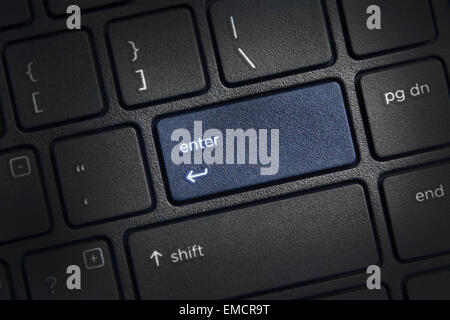 laptop computer keyboard with highlighted enter key button Stock Photo