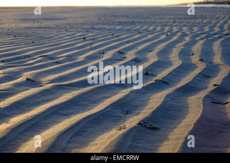 Ripples in the sand on the beach caused by the retreating tide Stock Photo