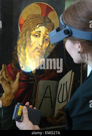 Restorer Ramona Roth looks at the painting 'Christus als Erloeser' (lit. Christ as Savior) from the workshop of Sandro Botticelli is seen at the workshop of the Gemaeldegalerie in Berlin, Germany, 20 April 2015. The painting, which was kept in the depot of the Gemaeldegalerie is currently being restored. It will be part of the exhitbition 'The Botticelli Renaissance' which will open on 24 September 2015. Photo: Stephanie Pilick/dpa Stock Photo