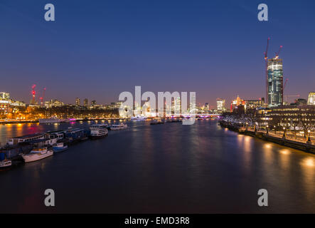 The City of London Skyline at Dusk showing boats, buildings and construction. There is copy space in the image. Stock Photo