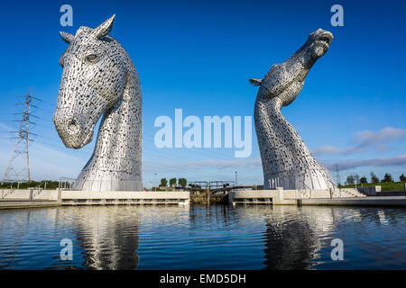 Dramatic daytime shot of the Kelpies statues in Falkirk, Scotland, UK on a sunny day against a blue sky Stock Photo