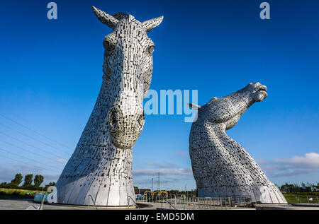 Dramatic daytime shot of the Kelpies statues in Falkirk, Scotland, UK on a sunny day against a blue sky Stock Photo