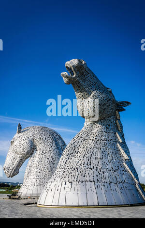 Dramatic daytime shot of the Kelpies statues in Falkirk, Scotland, UK on a sunny day against a blue sky Stock Photo