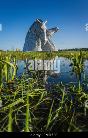 Dramatic daytime shot of the Kelpies statues in Falkirk, Scotland, UK on a sunny day against a blue sky Stock Photo