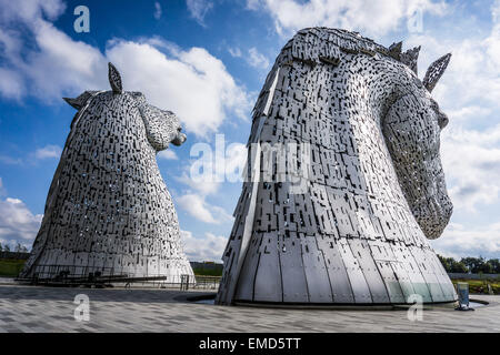 Dramatic daytime shot of the Kelpies horse head statues sculpture monument in Falkirk, Scotland, UK on a sunny day against a blue sky Stock Photo