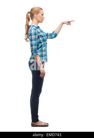 A teenage girl standing in profile wearing leggings and a brown T-shirt  Stock Photo - Alamy
