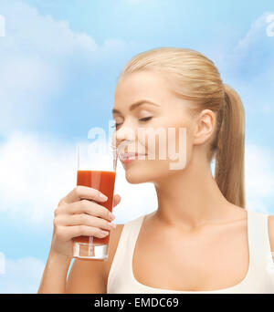 young woman drinking tomato juice Stock Photo
