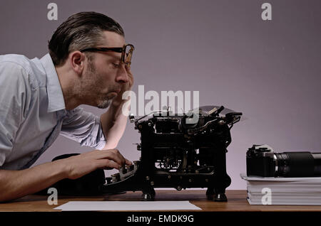 Editor with an old typewriter and retro camera on a wooden office table Stock Photo