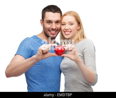 smiling couple holding small red heart Stock Photo