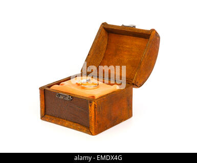 Two wedding rings in open treasure box against white background Stock Photo