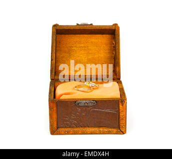 Wedding rings in open treasure box against white background Stock Photo