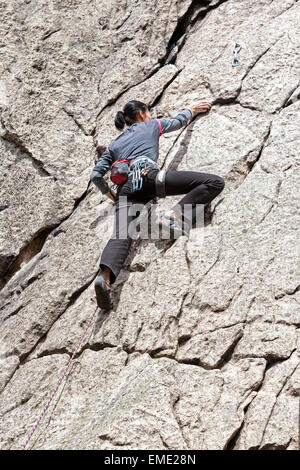 Young woman climbing difficult wall, rock climbing in polish mountains. Stock Photo