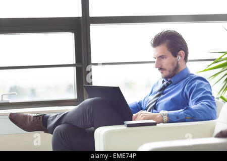 Businessman in office working on his laptop. Stock Photo