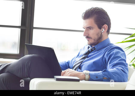 Businessman in office working on his laptop. Stock Photo