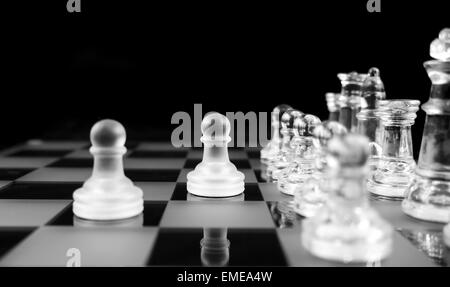 Glass Chess Pieces on a Frosted Glass Chess Board Stock Photo