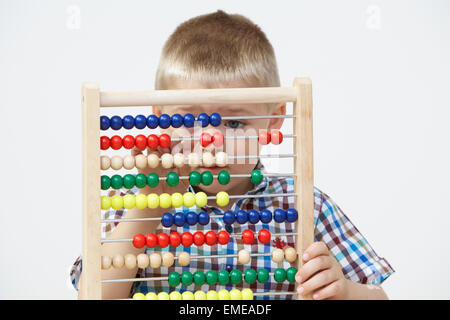Studio Shot Of Boy Playing With Abacus Stock Photo