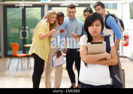Female Student Being Bullied By Classmates Stock Photo