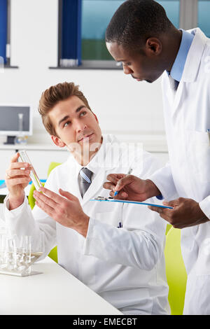 Two Technicians Working In Laboratory Stock Photo
