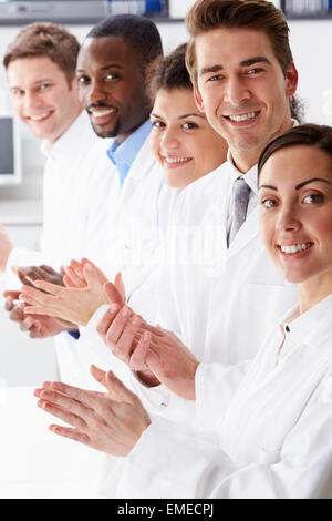 Portrait Of Technician And Colleagues In Laboratory Clapping Stock Photo