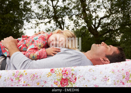 Father With Daughter Relaxing On Camping Holiday Stock Photo