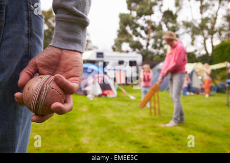Family Playing Cricket Match On Camping Holiday Stock Photo