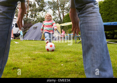 Family Having Football Match On Camping Holiday Stock Photo