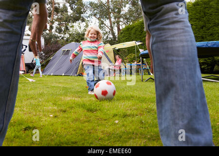 Family Having Football Match On Camping Holiday Stock Photo