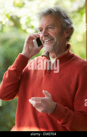 Mature Man Using Mobile Phone At Home Stock Photo