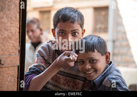 Boys looking through window of rickshaw Nagaur, Rajasthan, India Stock Photo