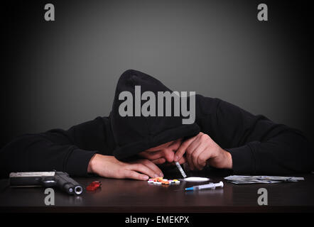 young drug addict man sniffing cocaine Stock Photo