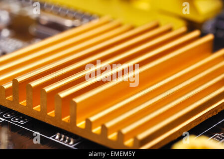 Yellow chipset heatsink on motherboard, close up Stock Photo