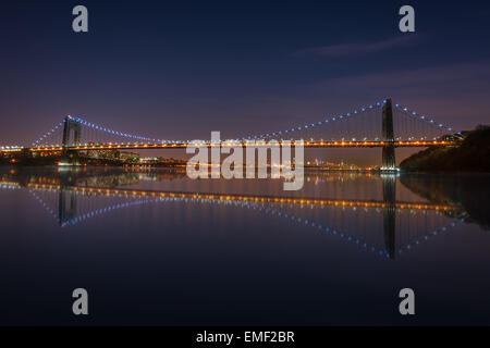 The George Washington Bridge spanning the Hudson River at night in New York City.