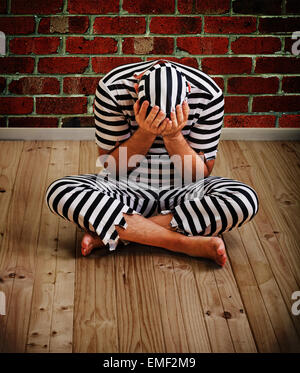 portrait of a repentant man prisoner in prison uniform Stock Photo