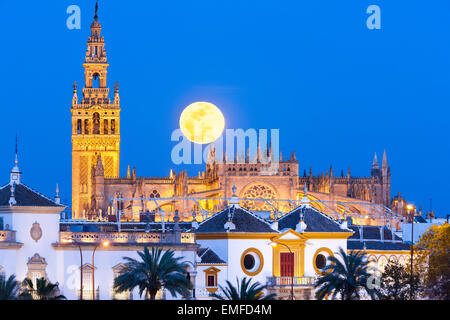 Seville Spain Seville Skyline with full moon rising behind La Giralda tower, Seville Cathedral de Sevilla, and Plaza de Toros Stock Photo