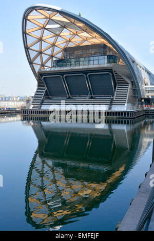 Crossrail Place retail shops business & roof garden building built above Canary Wharf Crossrail train station reflect water of West India Docks London Stock Photo