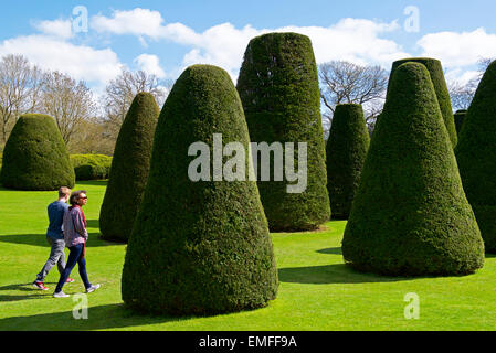 Young couple walking through the gardens of Packwood House, a National Trust property in Warwickshire, England UK Stock Photo