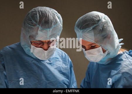 Two doctors working in a OP room Stock Photo
