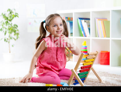 child girl playing with abacus Stock Photo