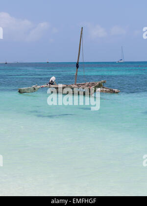 Traditional fishermen's dhow boat on turquoise water, Mbudya Island, close to Dar es Salaam, in Tanzania, East Africa. Stock Photo