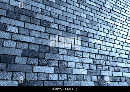 Angled view against a gray brick wall with additional light from the right Stock Photo