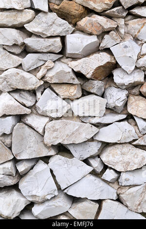 Stack of partly cut light beige to gray marble rocks Stock Photo