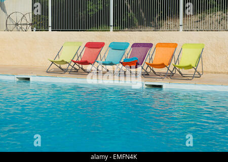 Row colorful chairs at the swimming pool Stock Photo