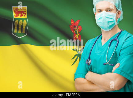 Surgeon with Canadian privinces flag on background - Saskatchewan Stock Photo